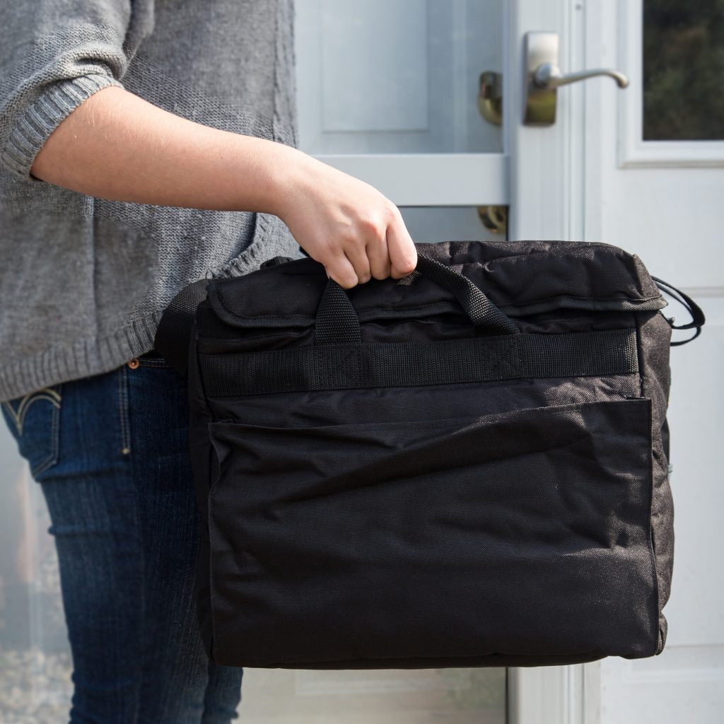 Person showcasing catering bag